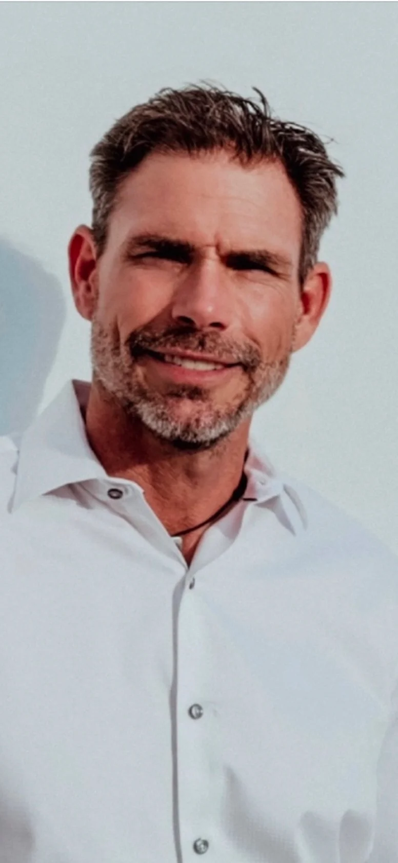 Professional headshot of male contractor in white button-up shirt