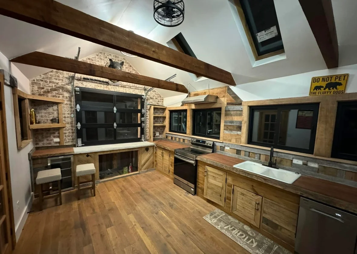 Modern kitchen remodel with wood cabinetry, stainless steel range, and exposed ceiling beams
