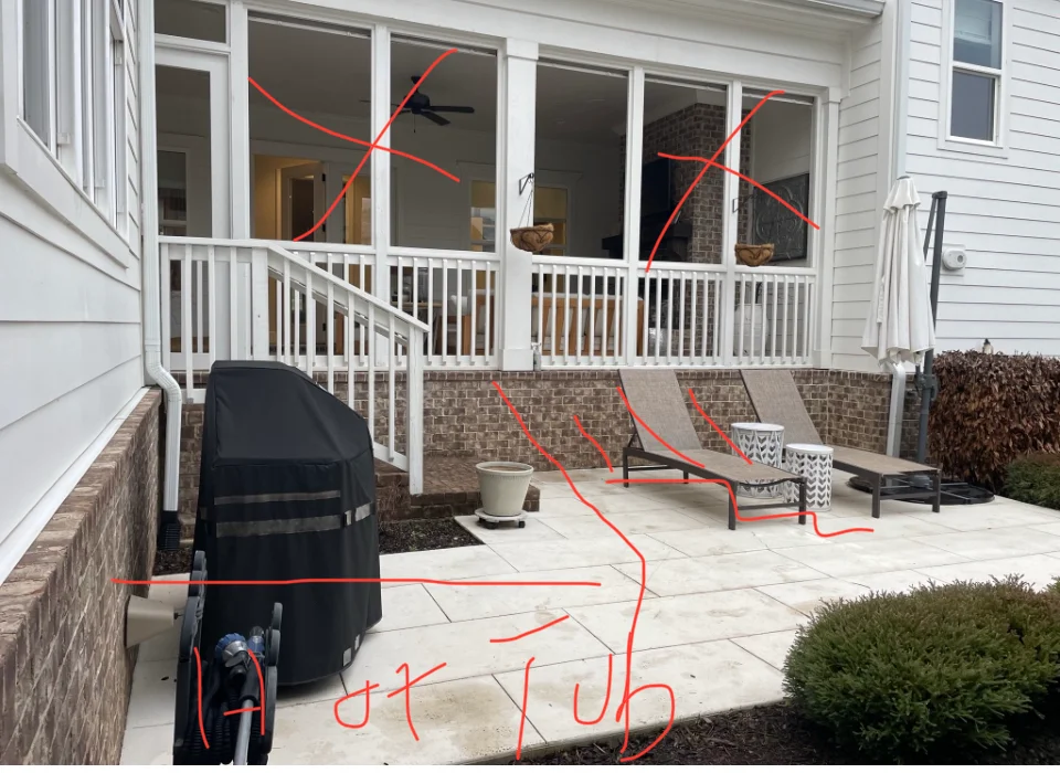 New patio with composite pavers and white vinyl deck railing attached to screened porch