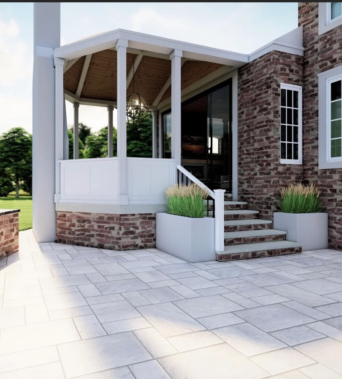 White screened porch with columns attached to brick home, paver patio, and landscaping planters