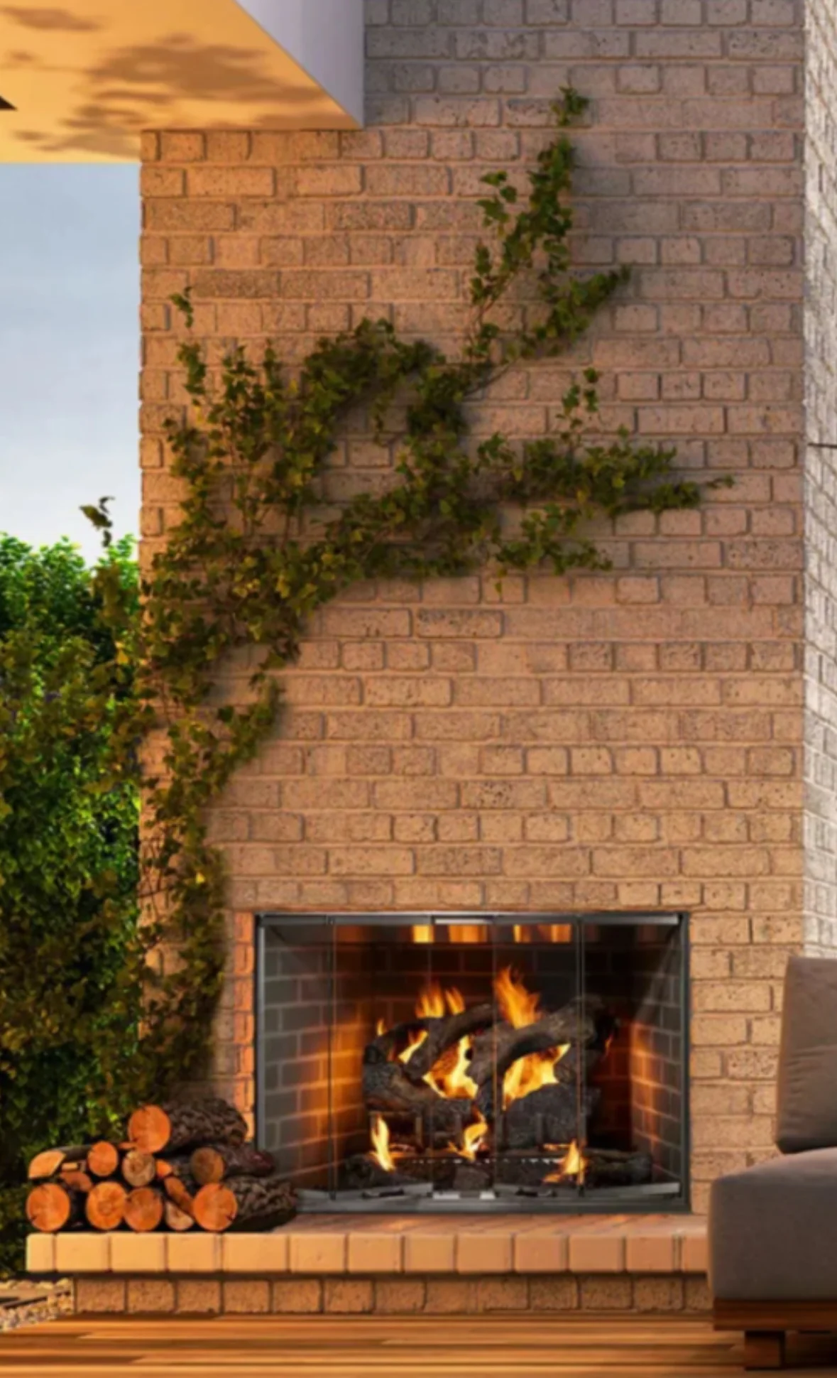 Brick fireplace with active fire, glass doors, and climbing ivy on exterior wall